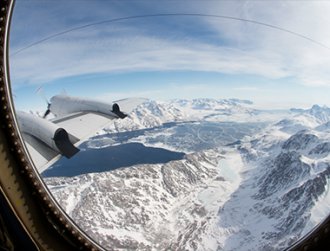 View of a snowcapped mountain from an airplane window